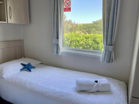 A bedroom with a single bed and a window at the property in unspecified location