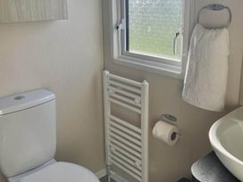 A bathroom with a toilet and sink at the property