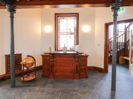 A hall with a wooden desk and globe at Capel Llani in Llanidloes