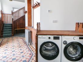A laundry room with a washing machine and dryer at Capel Llani in Llanidloes