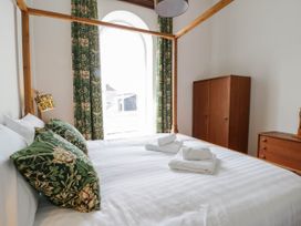 A bedroom with a bed and wardrobe at Capel Llani in Llanidloes