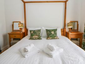 A bedroom with a bed and bedside tables at Capel Llani in Llanidloes