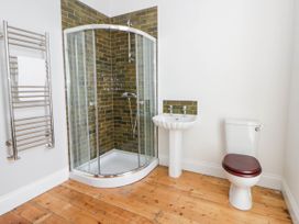 A bathroom with shower, toilet, and sink at Capel Llani in Llanidloes