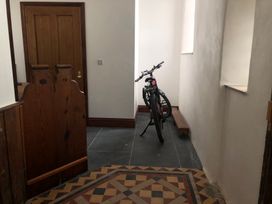 A hallway with a bicycle and bench at Capel Llani Llanidloes