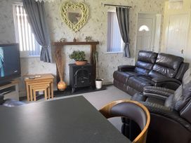 A living room with a television and a fireplace at Ivy Corner