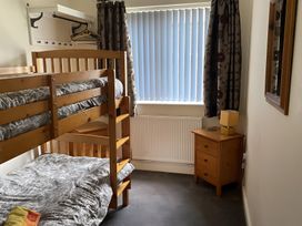 A bedroom with a bunk bed and side table at Ivy Corner