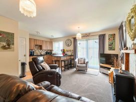 A living room with a sofa, coffee table, and television at Ivy Corner in Bridlington