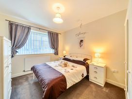 A bedroom with a bed and a dresser at Ivy Corner in Bridlington