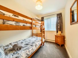 A bedroom with a bunk bed and nightstand at Ivy Corner in Bridlington