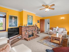 A living room with a fireplace and television at the property