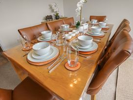 A dining table set with plates and glasses at the dining room in 
