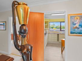 A sculpture and kitchen view with a doorway at the property in 