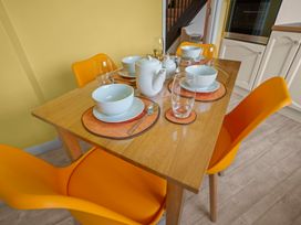 A dining room table set with bowls and glassware at The Old Barn in Manchester