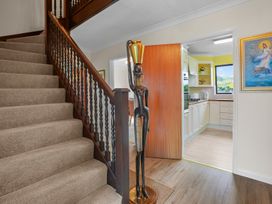 A hallway with stairs and a kitchen entrance at The Old Barn in Manchester