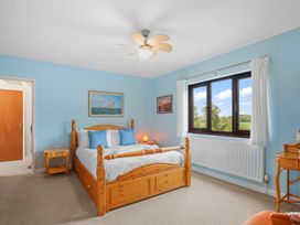 A bedroom with a bed and window at The Old Barn in Manchester