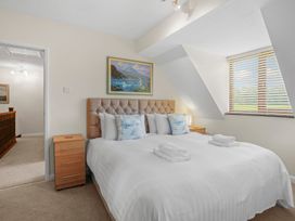 A bedroom with a bed and paintings at the property