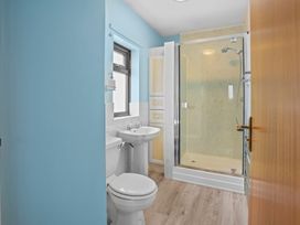 A bathroom with a toilet, sink, and shower at The Old Barn in Manchester