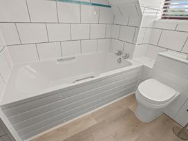 A bathroom with a bathtub and toilet at The Old Barn in Manchester