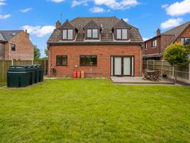 A house with a garden and decking at the outdoor area