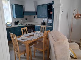 A kitchen with a dining table and chairs at Fisherman's Cottage