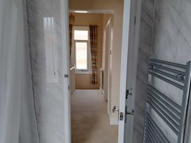 A bathroom with a shower and window at Fisherman's Cottage
