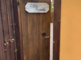 A wooden door with a sign reading 'Little Russets'