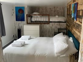 A bedroom with a bed and bunk bed at Little Russets