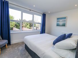 A bedroom with a bed and window at Sea Fern House - 36 in Poole