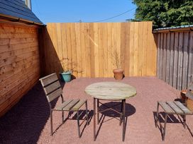 An outdoor seating area with a wooden table and chairs at location