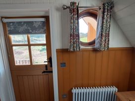 An entryway with a door and a round window at the property located in 