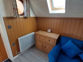 A corner with a radiator and a wooden cabinet at a property