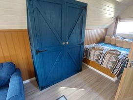 A bedroom with a blue wardrobe and a bed at an unspecified location