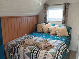 A bedroom with a bed and pillows at The Old Barn in Manchester