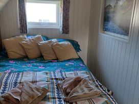 A bedroom with a bed and pillows at the property