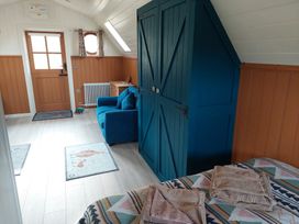 A bedroom with a wardrobe and a chair at the property in unspecified location