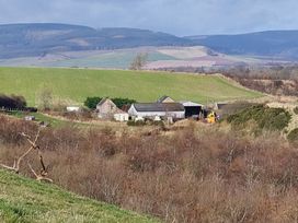 A farmhouse and surrounding buildings on a farm in a rural area