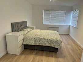 A bedroom with a bed and bedside tables at Red Rose Apartment