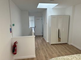A bedroom with a wardrobe and door at Red Rose Apartment