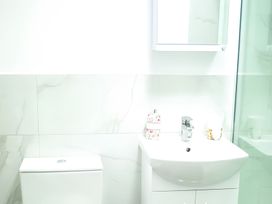A bathroom with a sink and toilet at Red Rose Apartment