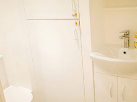 A bathroom with a toilet and sink at Red Rose Apartment