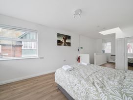 A bedroom with a bed and wardrobe at Red Rose Apartment in Weymouth