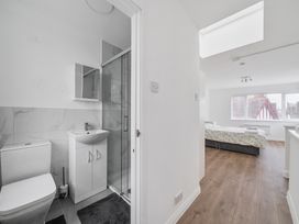 A bathroom with a shower and sink at Red Rose Apartment in Weymouth