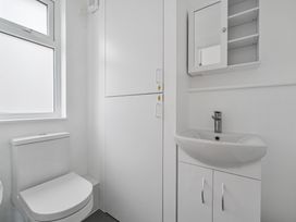 A bathroom with a toilet and sink at Red Rose Apartment in Weymouth