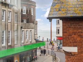 A street view with buildings and people walking at Red Rose Apartment in Weymouth