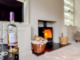 A living room with a bottle of Pinot Grigio and glasses at Victorian Beach House