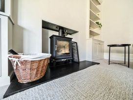 A living room with a fireplace and a storage cabinet at Victorian Beach House in Saltburn-By-The-Sea