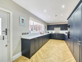 A kitchen with cabinets and appliances at Victorian Beach House in Saltburn-By-The-Sea