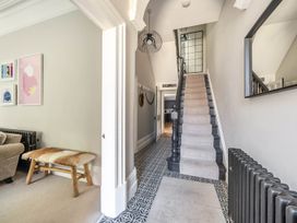 A hallway with a staircase and pictures at Victorian Beach House in Saltburn-By-The-Sea