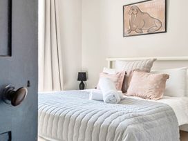 A bedroom with a bed and decorative pillows at Victorian Beach House in Saltburn-By-The-Sea