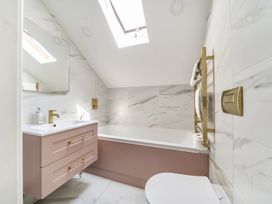 A bathroom with a bathtub and sink at Victorian Beach House in Saltburn-By-The-Sea